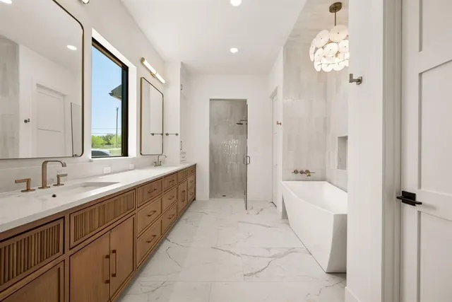 a spacious bathroom with a double vanity sink mirror and shower