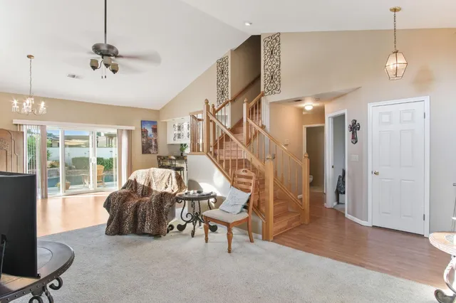 a living room with furniture and a chandelier