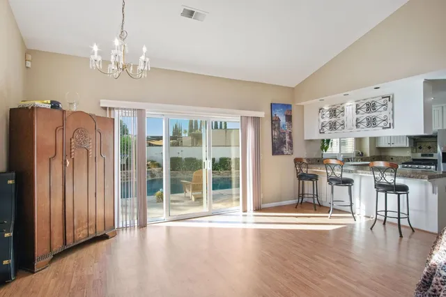 a view of a dining room with furniture wooden floor and chandelier