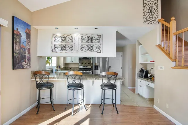 a living room with fireplace furniture and a large window