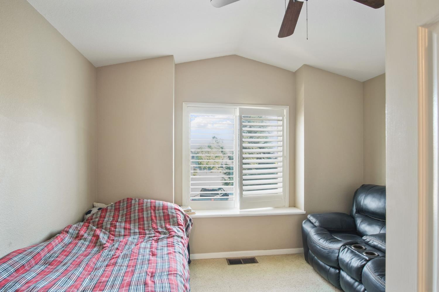 1345 Alex Circle Turlock, CA 95382 - Photo 21 of 35 a bedroom with a bed and a chair