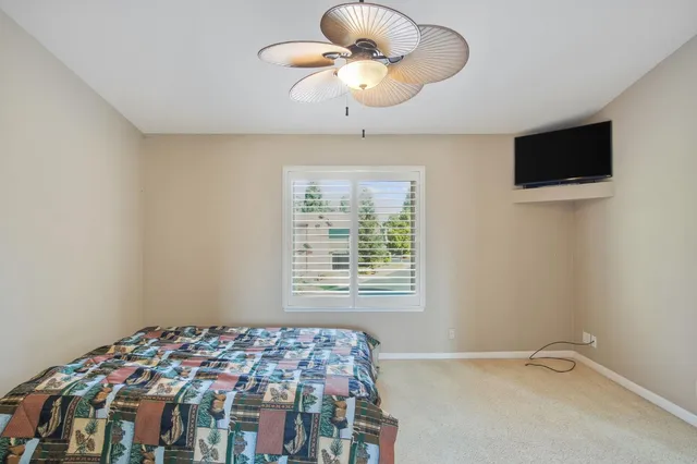 a bedroom with bed and window