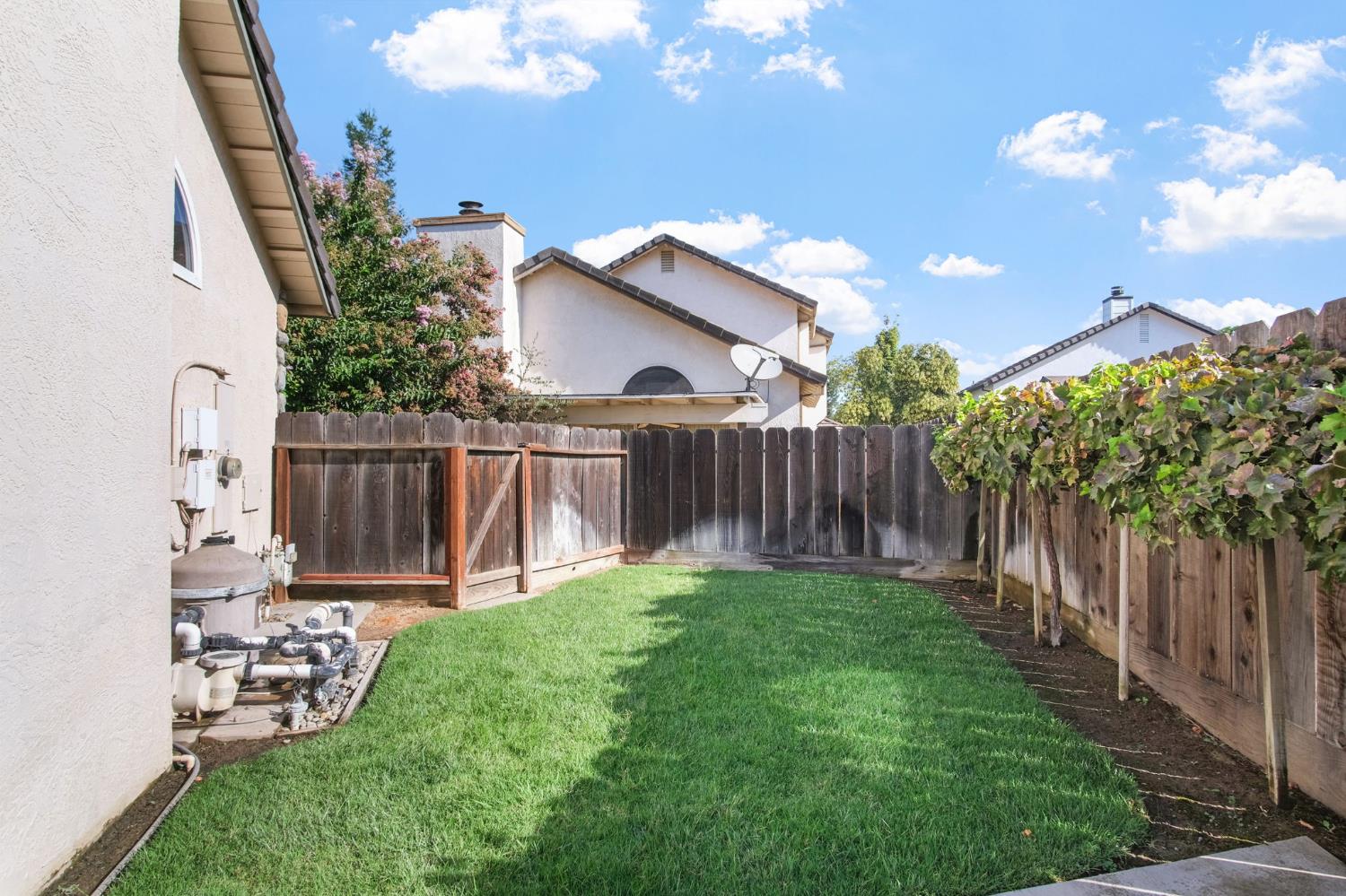 1345 Alex Circle Turlock, CA 95382 - Photo 30 of 35 a view of a backyard with wooden fence and a bench