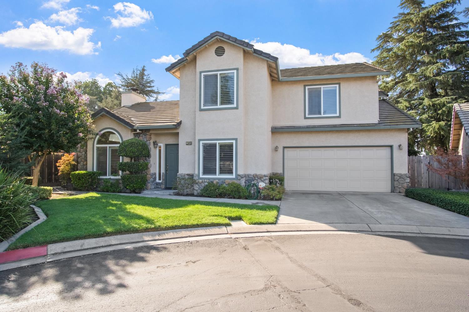 1345 Alex Circle Turlock, CA 95382 - Photo 4 of 35 a front view of a house with a yard and garage