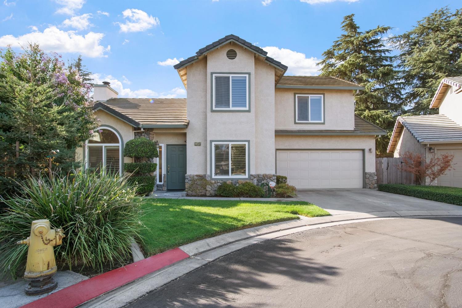 1345 Alex Circle Turlock, CA 95382 - Photo 5 of 35 a front view of a house with a yard and garage