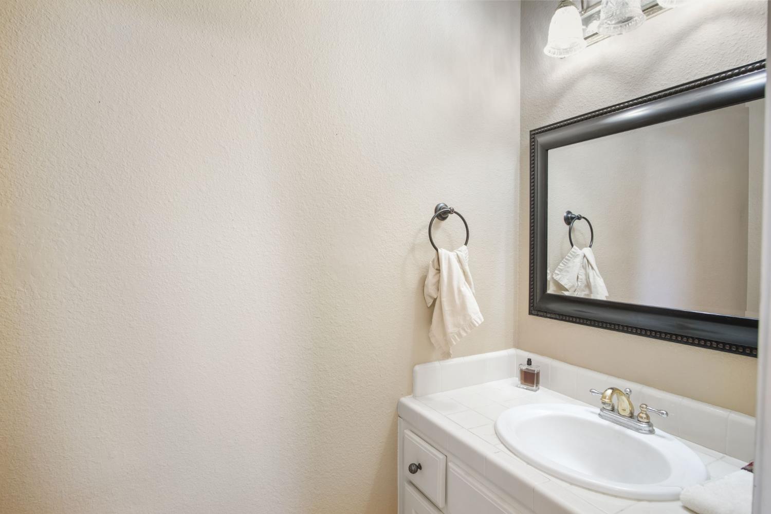 1345 Alex Circle Turlock, CA 95382 - Photo 8 of 35 a bathroom with a sink vanity and a mirror