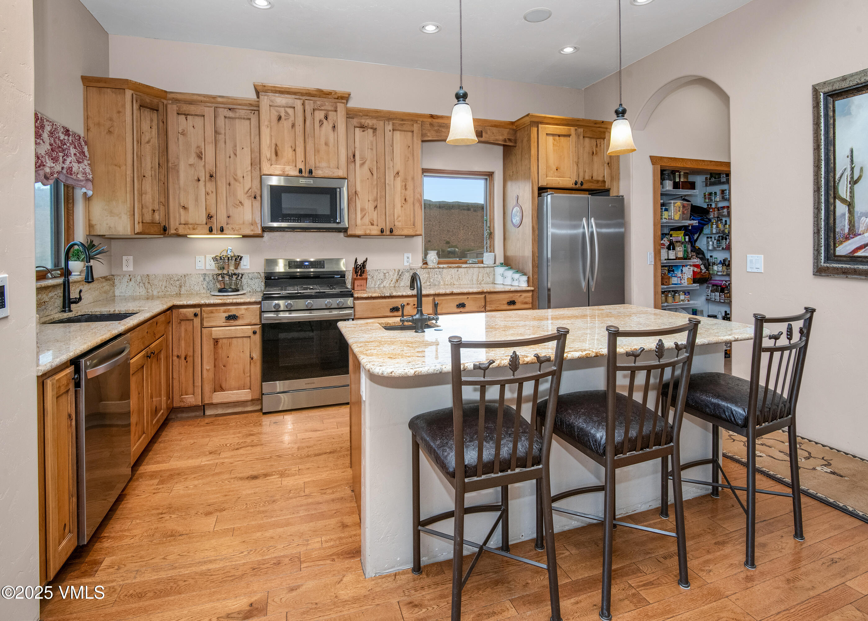 14555 Highway 6 Eagle, CO 81631 - Photo 11 of 61 a kitchen with stainless steel appliances a table chairs sink and cabinets