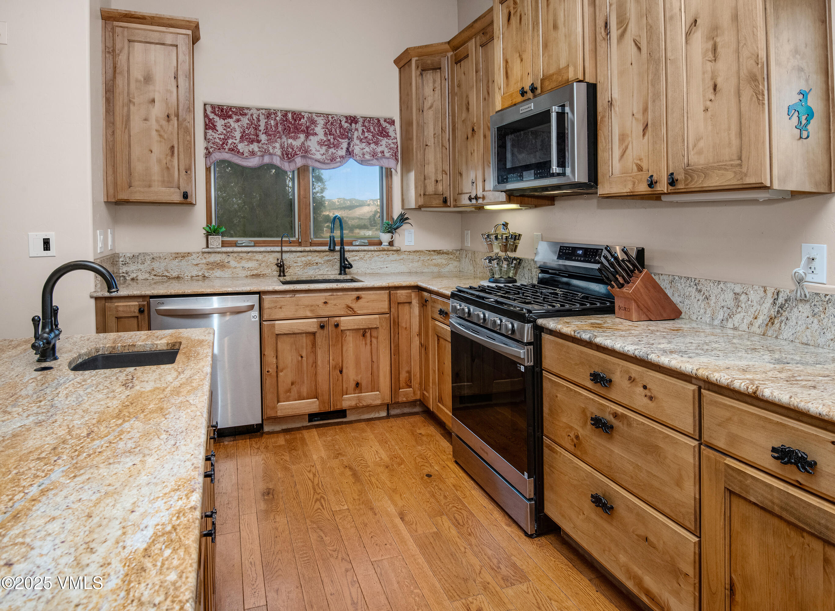 14555 Highway 6 Eagle, CO 81631 - Photo 12 of 61 a kitchen with stainless steel appliances granite countertop a sink stove and cabinets
