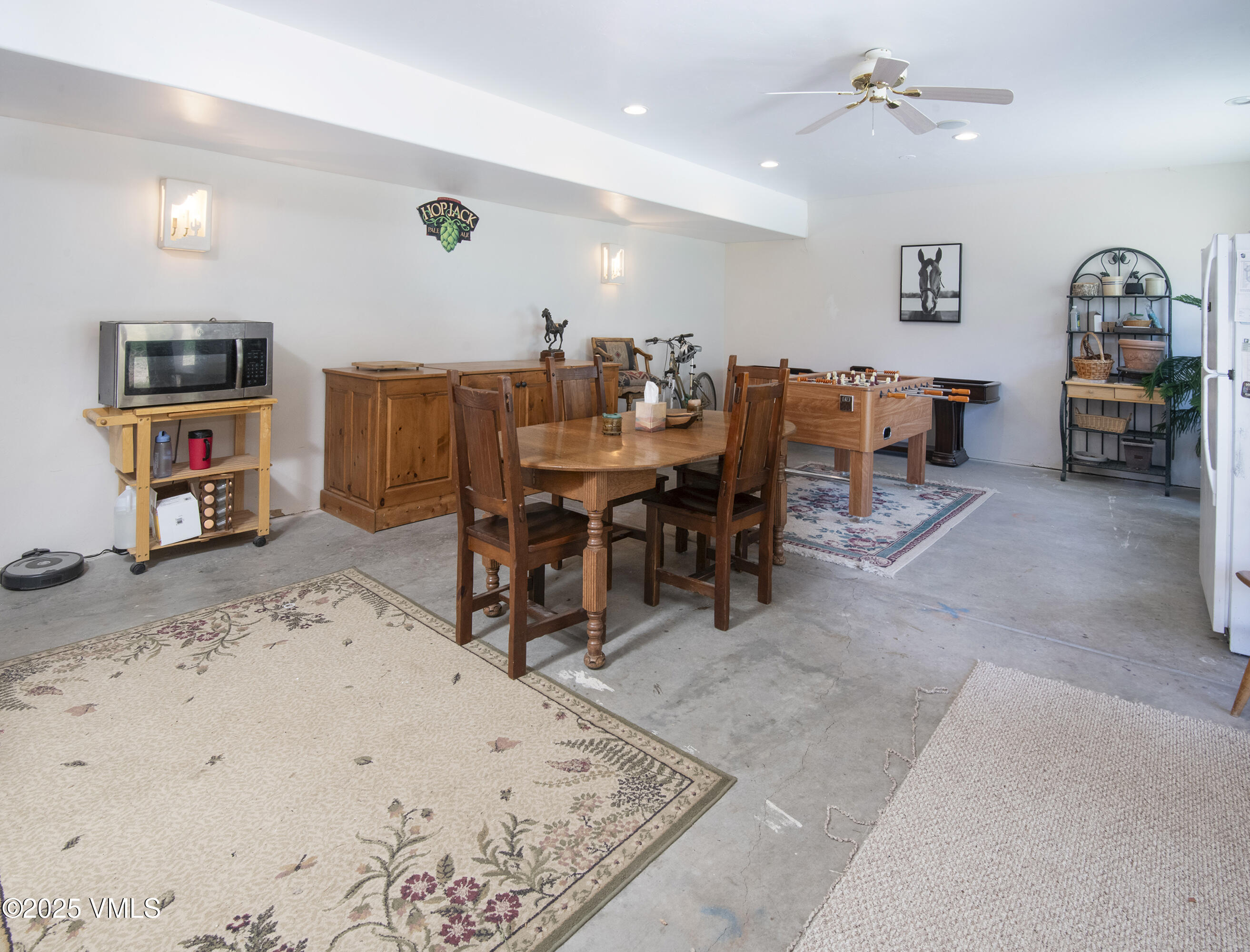 14555 Highway 6 Eagle, CO 81631 - Photo 28 of 61 a living room with furniture a flat screen tv and a dining table