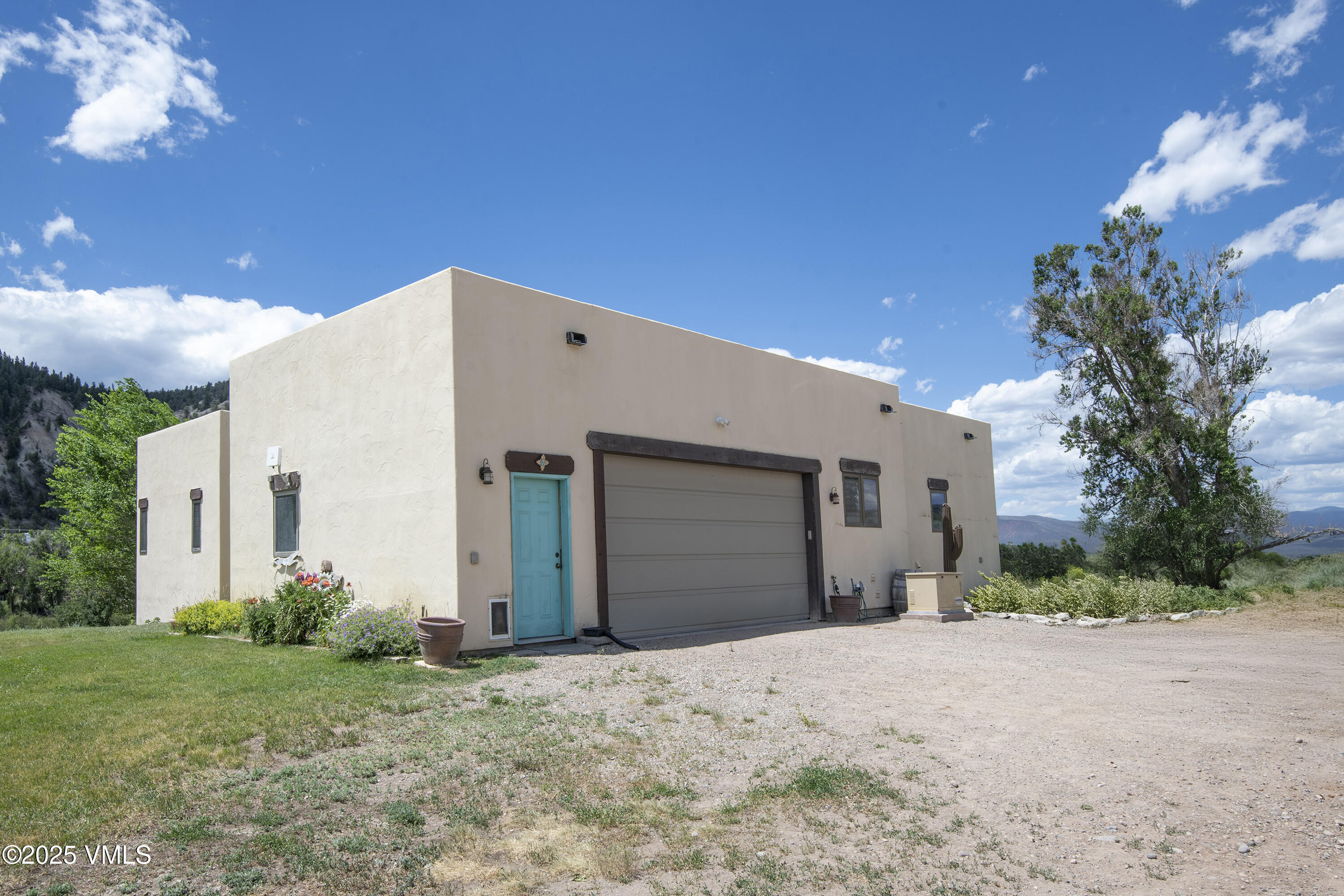 14555 Highway 6 Eagle, CO 81631 - Photo 31 of 61 a front view of a house with a yard and garage