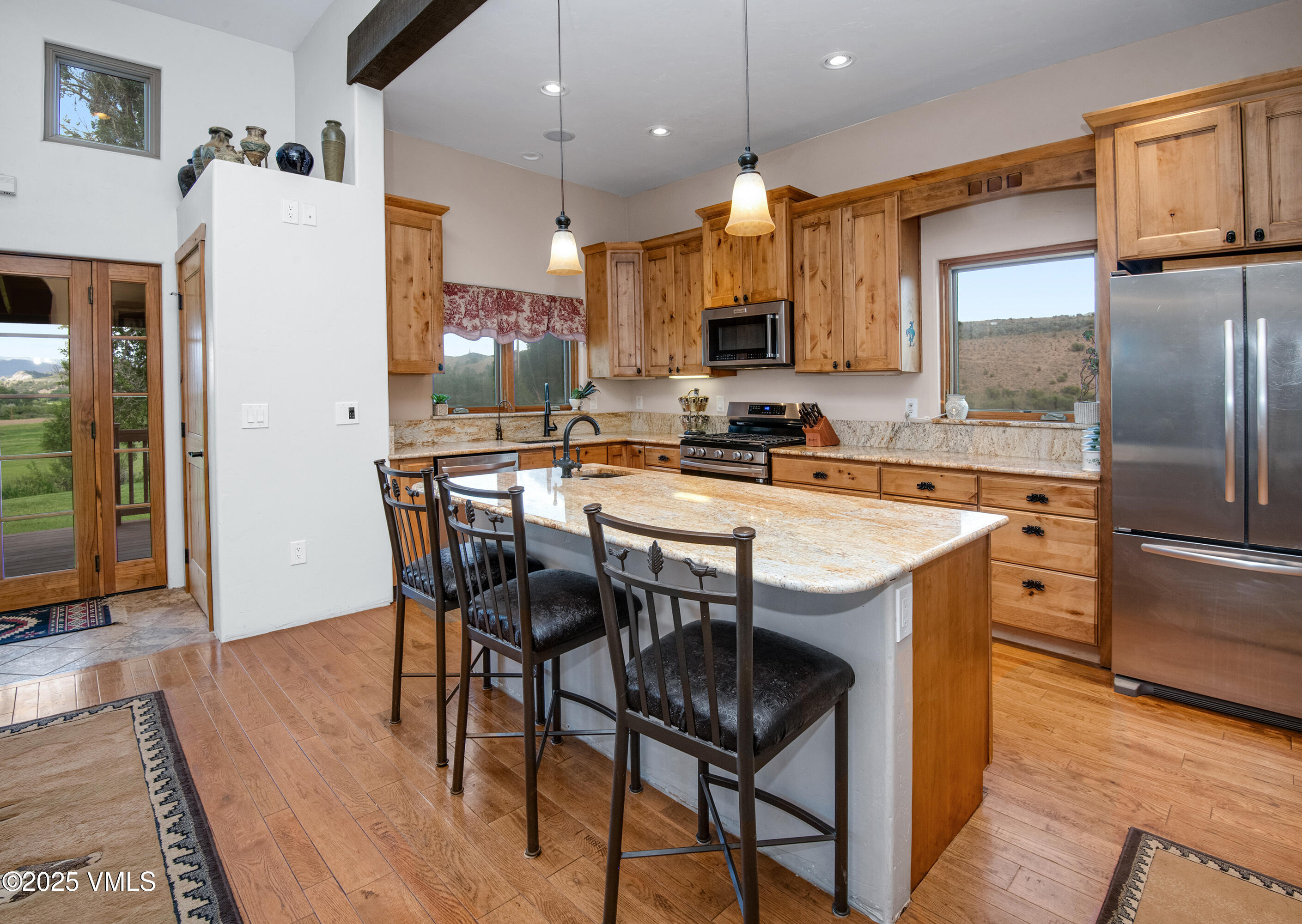 14555 Highway 6 Eagle, CO 81631 - Photo 10 of 61 a kitchen with stainless steel appliances granite countertop a table chairs stove and refrigerator