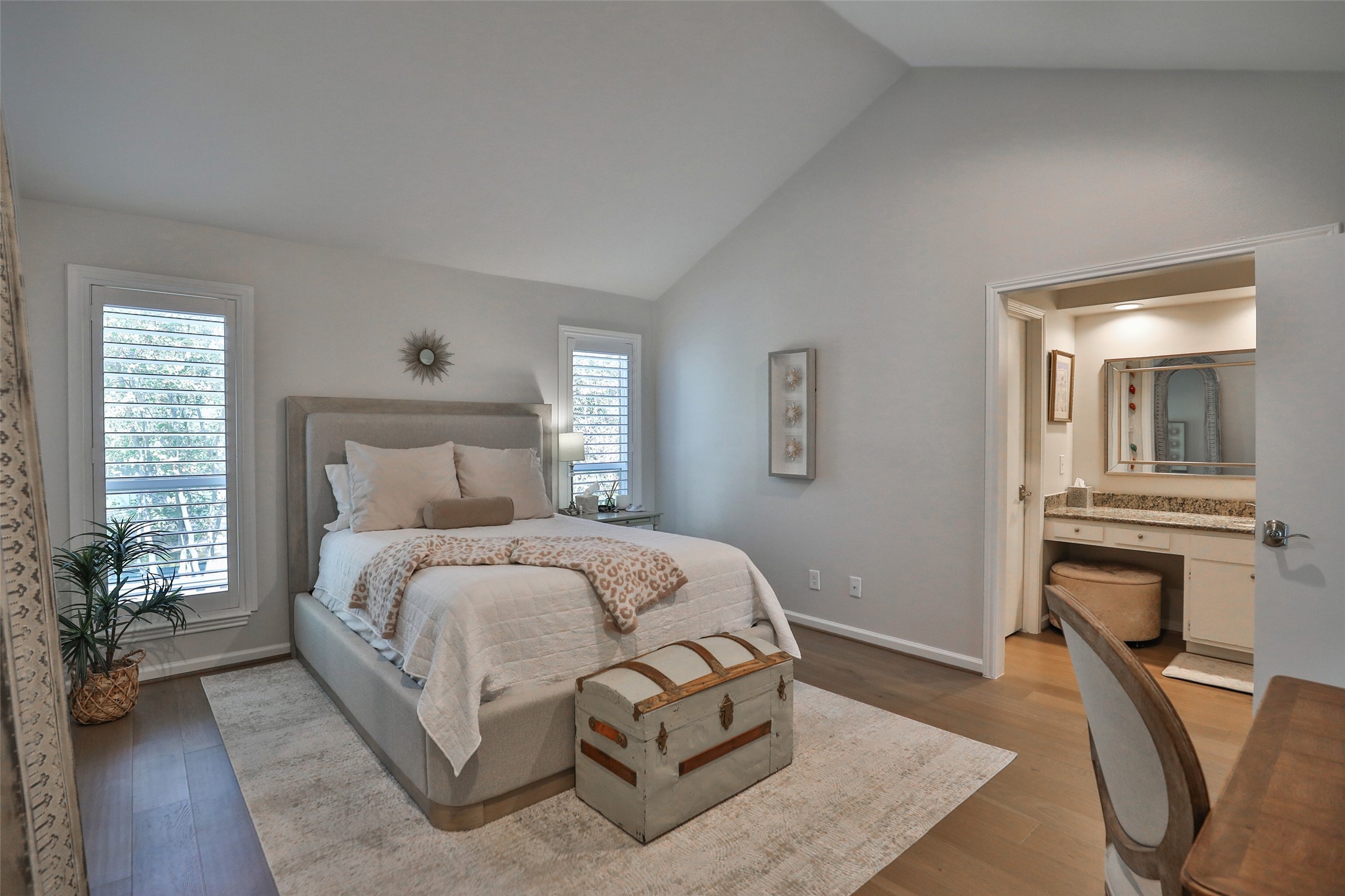 979 Memorial Village Drive, Unit 48 Houston, TX 77024 - Photo 12 of 18 a bedroom with a bed and wooden floor