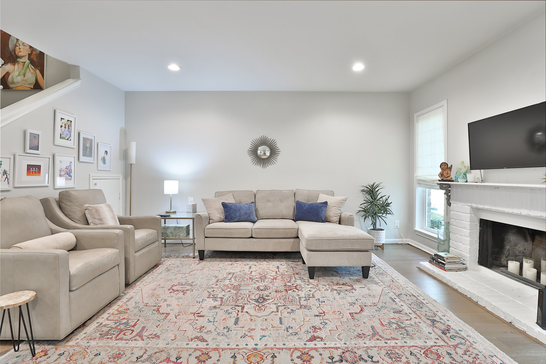 979 Memorial Village Drive, Unit 48 Houston, TX 77024 - Photo 3 of 18 a living room with furniture a fireplace and a flat screen tv