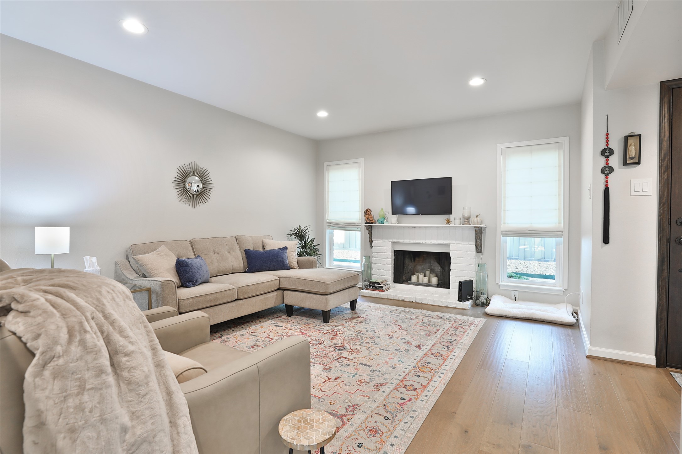 979 Memorial Village Drive, Unit 48 Houston, TX 77024 - Photo 4 of 18 a living room with furniture a fireplace and a flat screen tv