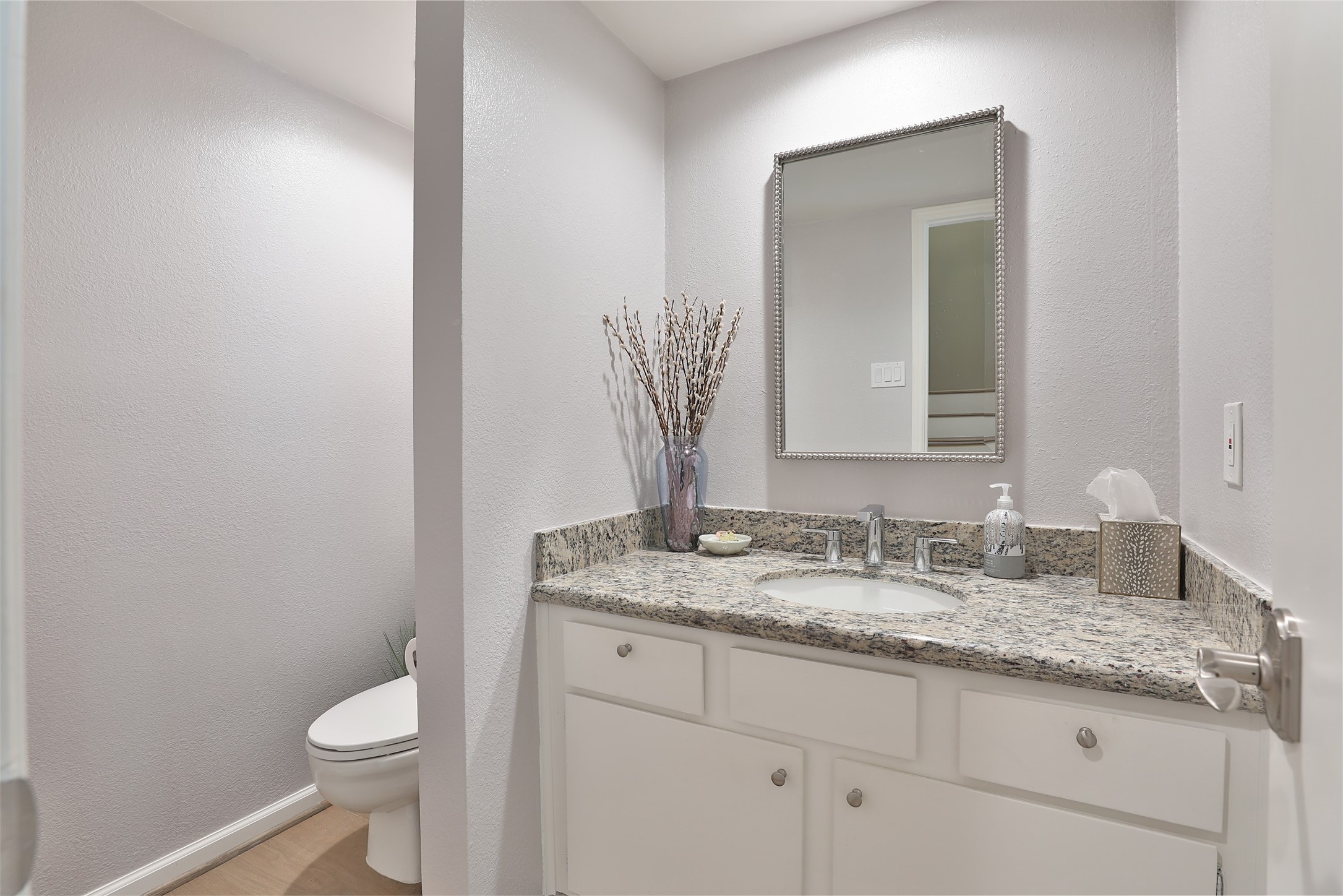 979 Memorial Village Drive, Unit 48 Houston, TX 77024 - Photo 5 of 18 a bathroom with a granite countertop toilet sink and mirror