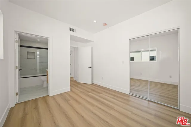 a bathroom with a sink a mirror a toilet and shower