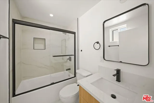 a bathroom with a shower and toilet