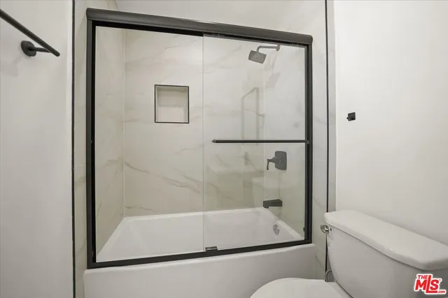 an empty room with a wooden floor and a window