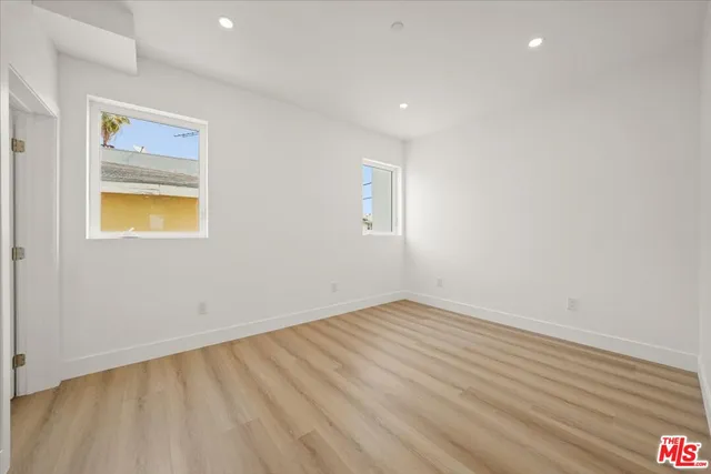 a view of a room with wooden floor