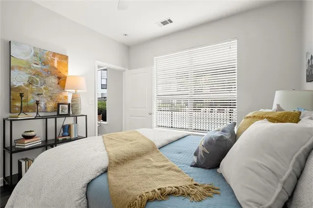 a bedroom with a bed wooden floor and window