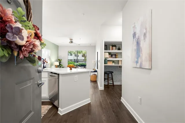 a kitchen with a refrigerator and a stove top oven
