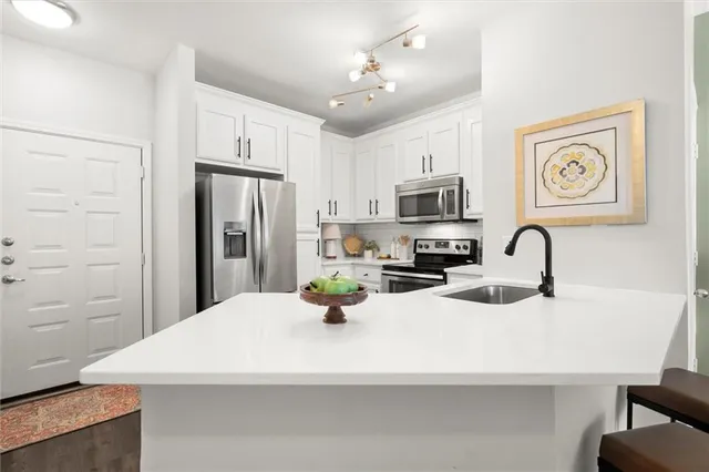 a kitchen with a refrigerator and a sink