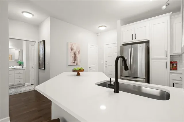 a kitchen with sink and a refrigerator