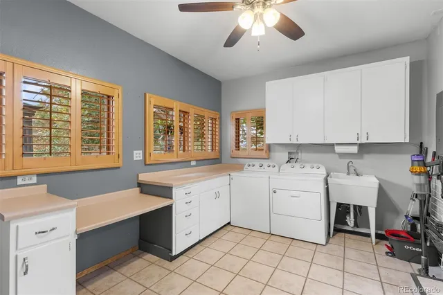 a kitchen that has a lot of cabinets in it and wooden floors