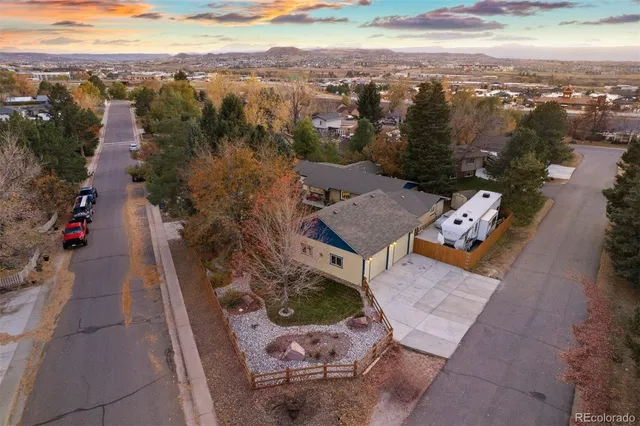 an aerial view of a house with a yard