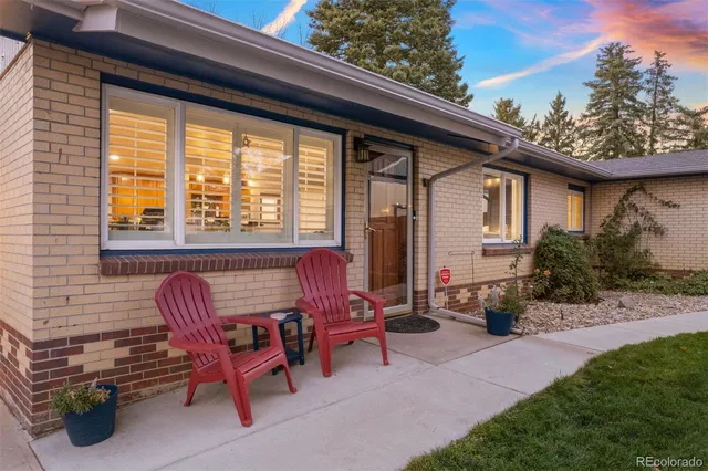 a view of backyard with outdoor seating and plants