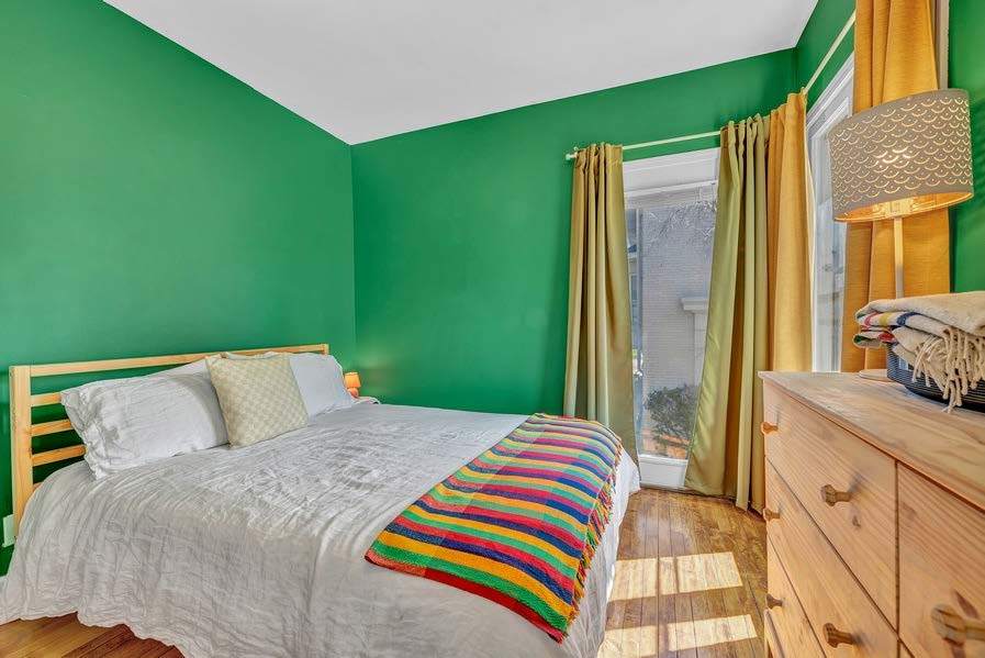 4249 North Hazel Street Chicago, IL 60613 - Photo 8 of 14 a bedroom with a bed and a dresser