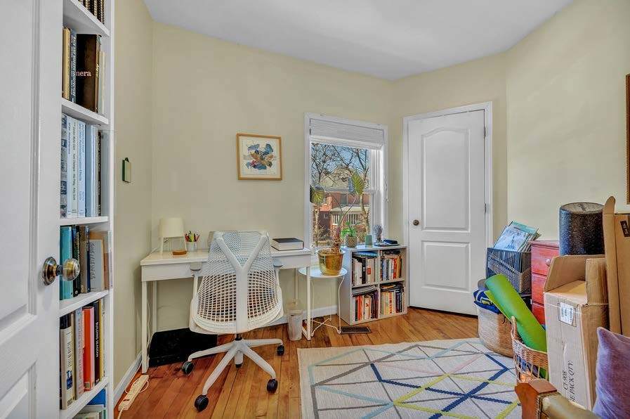 4249 North Hazel Street Chicago, IL 60613 - Photo 10 of 14 a view of living room filled with furniture and baby crib