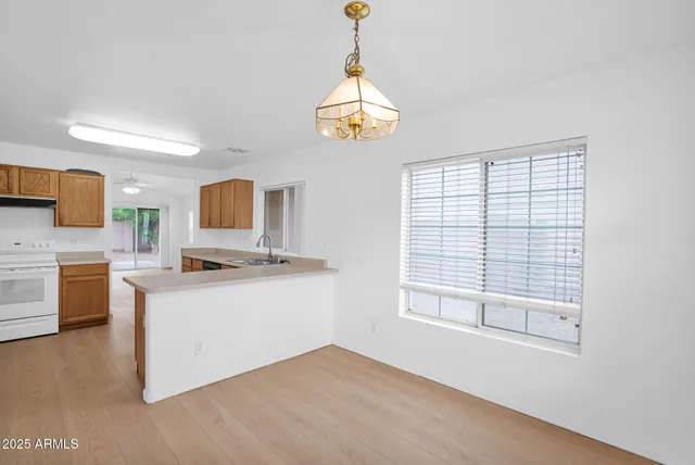 a kitchen with a refrigerator a sink and cabinets