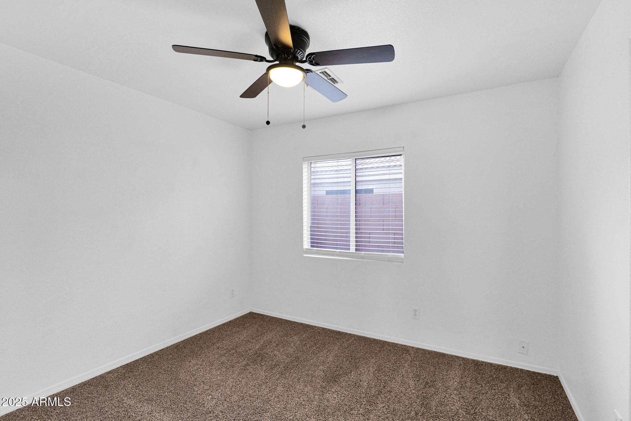 882 East Monterey Street Chandler, AZ 85225 - Photo 18 of 33 an empty room with a window and a fan