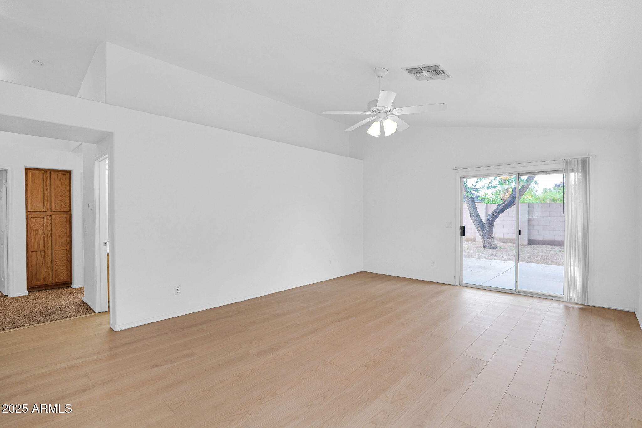 882 East Monterey Street Chandler, AZ 85225 - Photo 5 of 33 an empty room with fan and way to kitchen