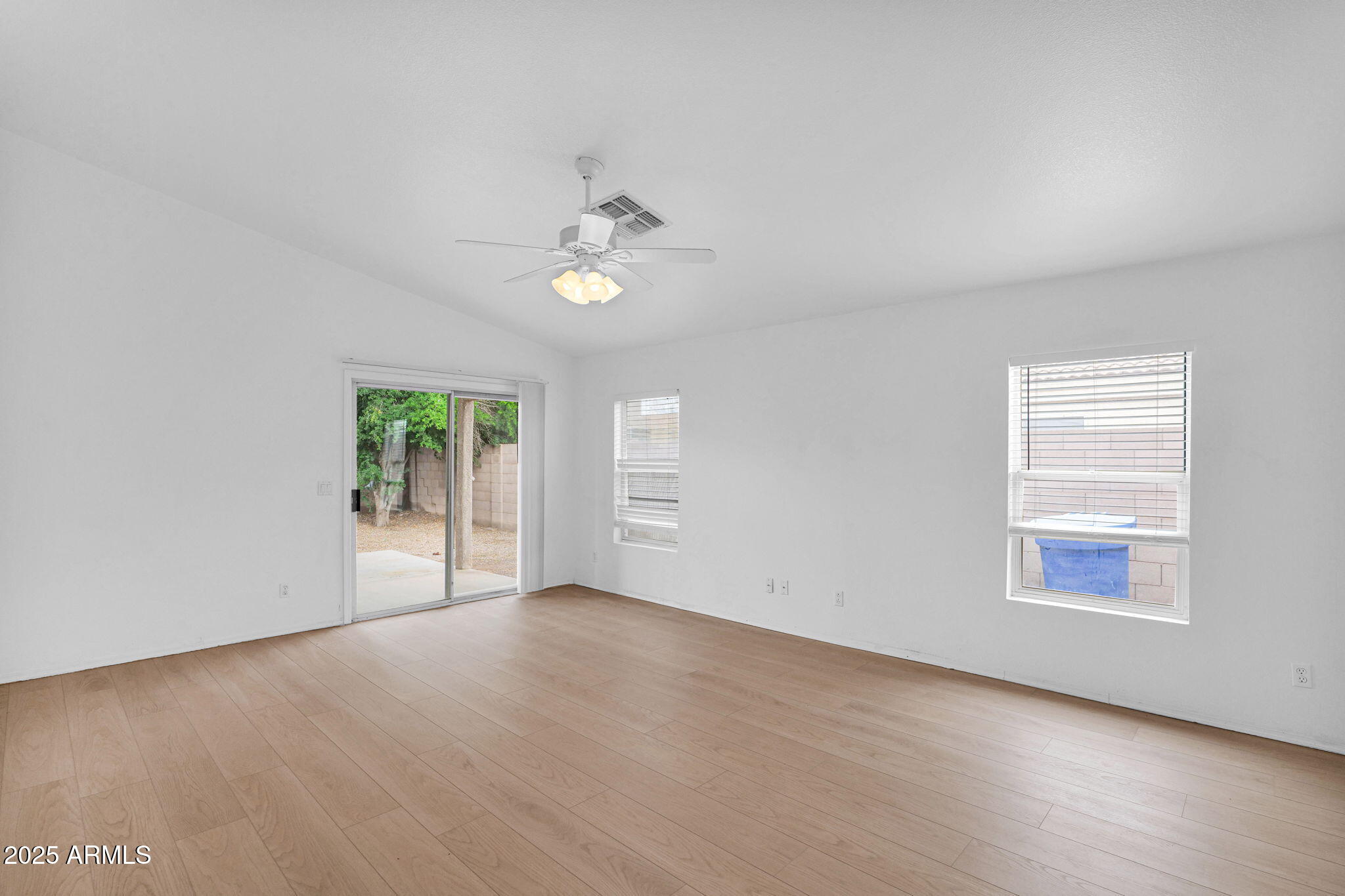 882 East Monterey Street Chandler, AZ 85225 - Photo 8 of 33 an empty room with windows and chandelier fan