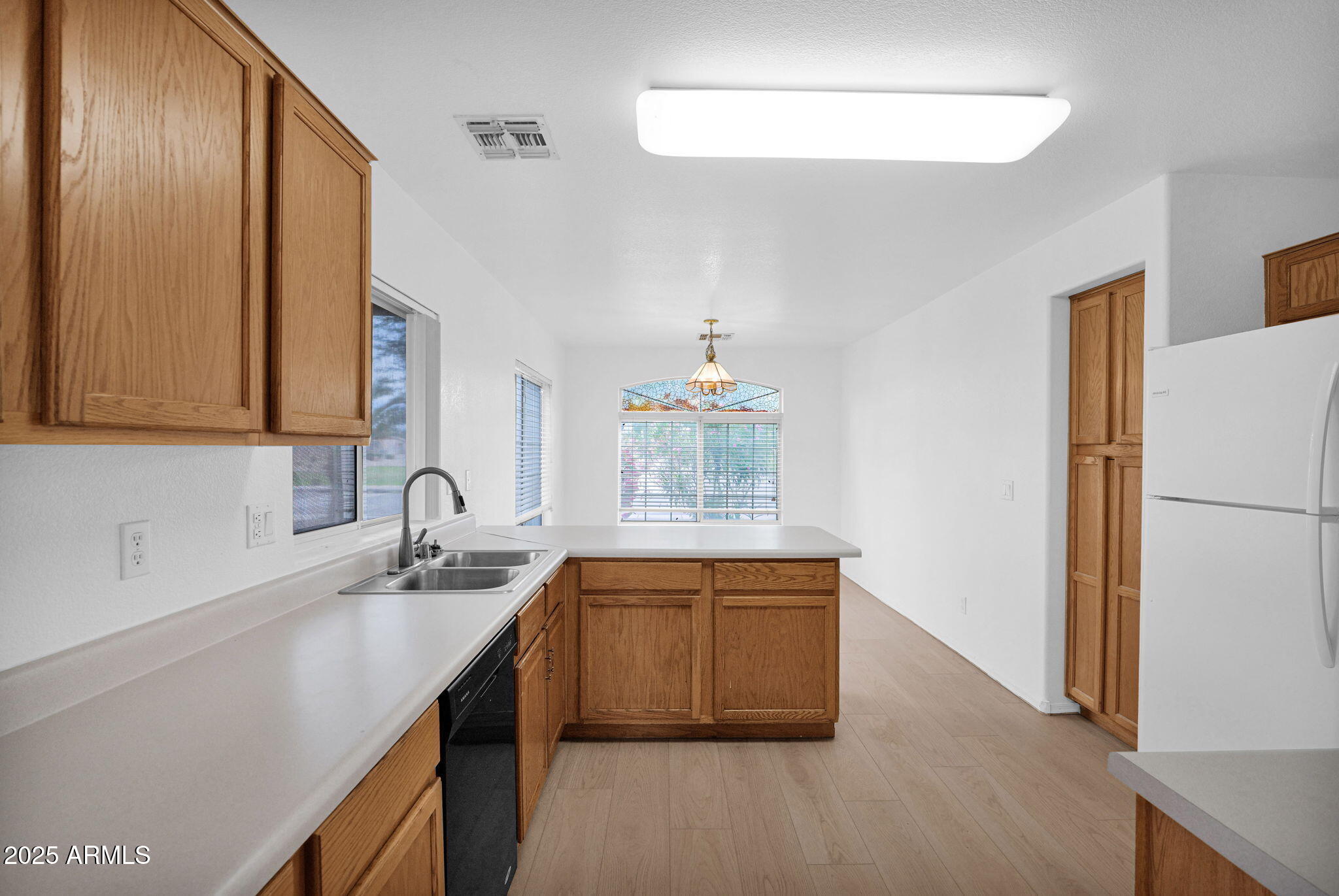 882 East Monterey Street Chandler, AZ 85225 - Photo 9 of 33 a kitchen with a sink and a refrigerator