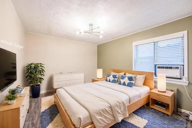 a bedroom with furniture and a flat screen tv