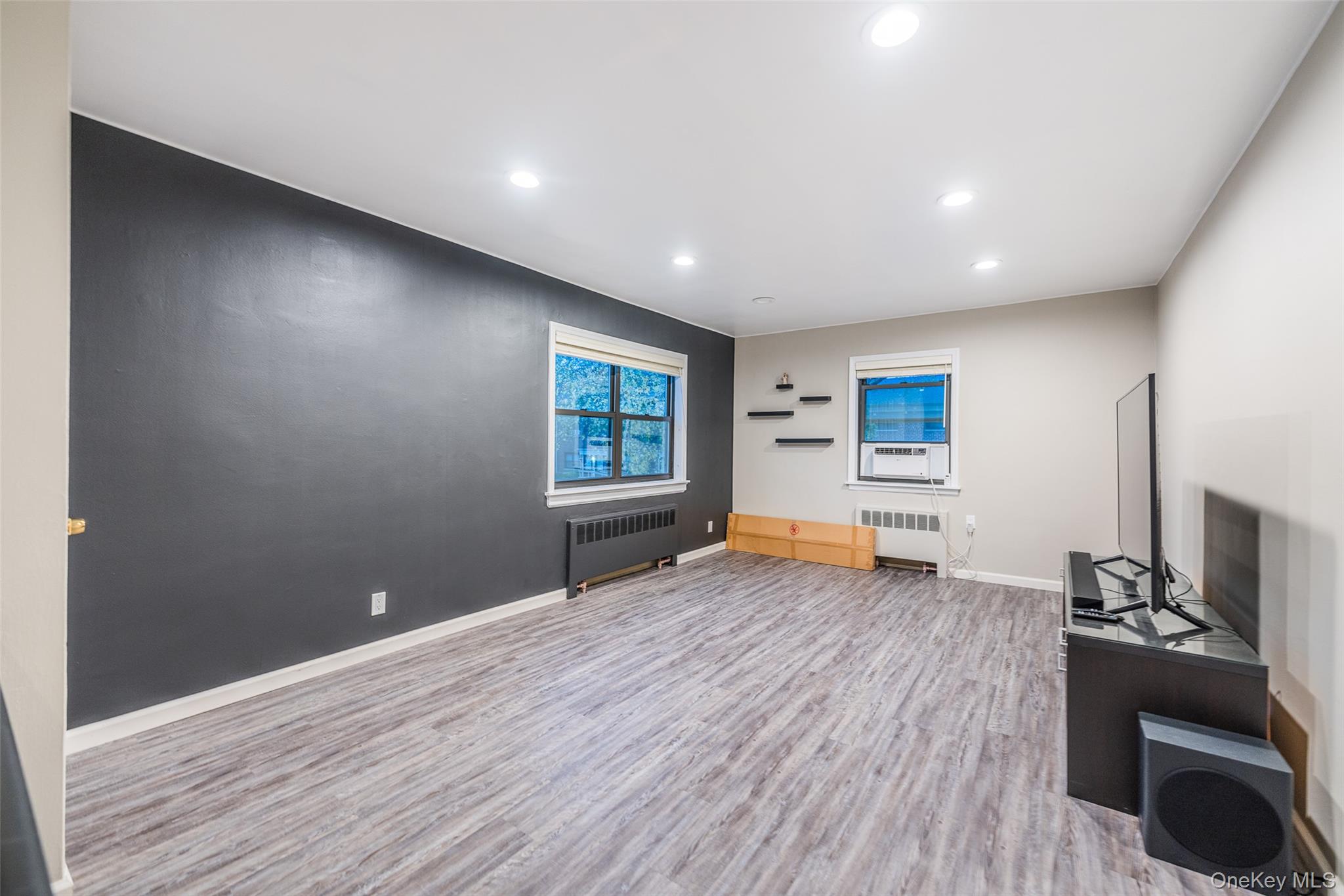 220-16 73rd Avenue, Unit 13A2 Queens, NY 11364 - Photo 9 of 18 a living room with furniture and a wooden floor