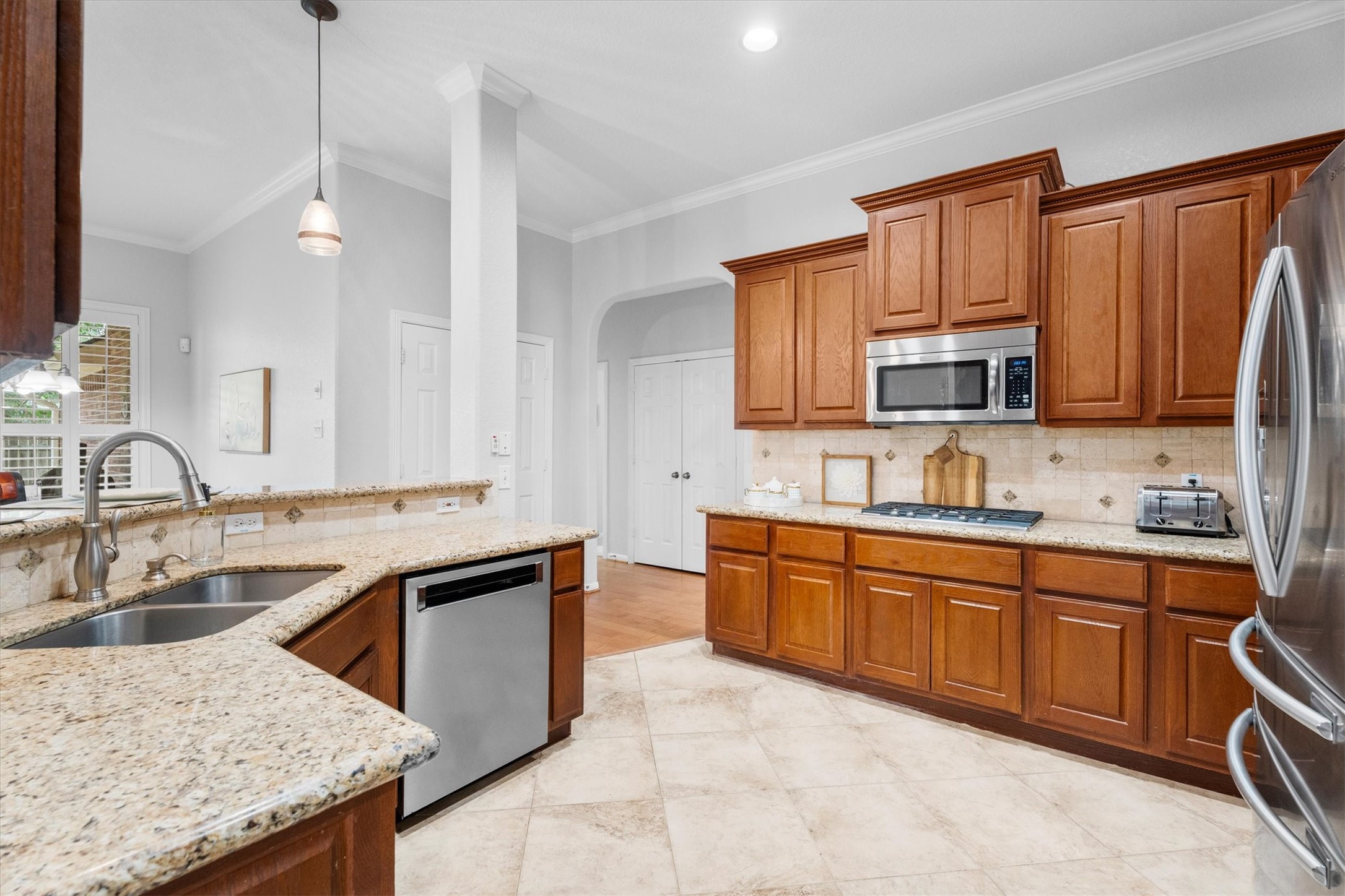9406 Lochflora Drive Spring, TX 77379 - Photo 13 of 49 a kitchen with stainless steel appliances granite countertop a sink stove and refrigerator