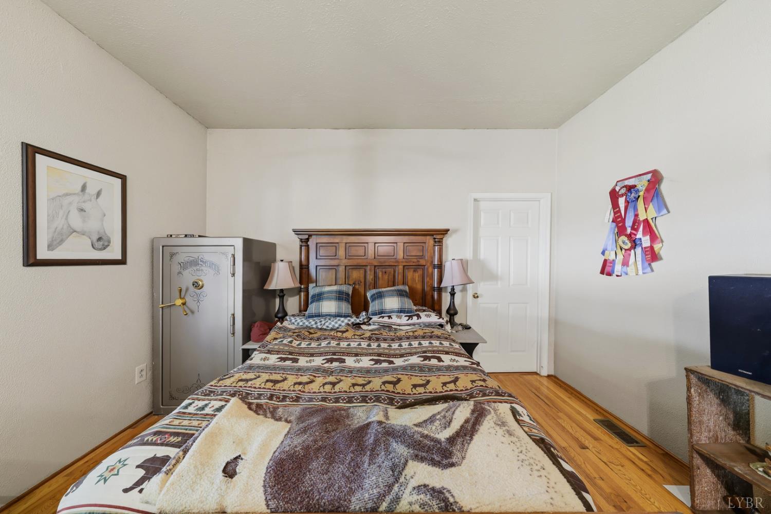 809 Plantation Road Amherst, VA 24521 - Photo 9 of 77 a bed sitting in a bedroom and painting on the wall