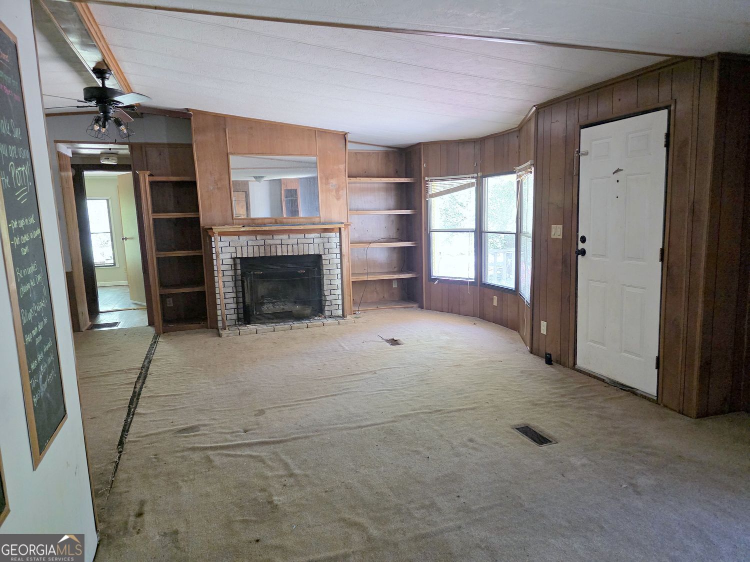 15 Shady Lane Jackson, GA 30233 - Photo 6 of 30 an empty room with windows and fireplace