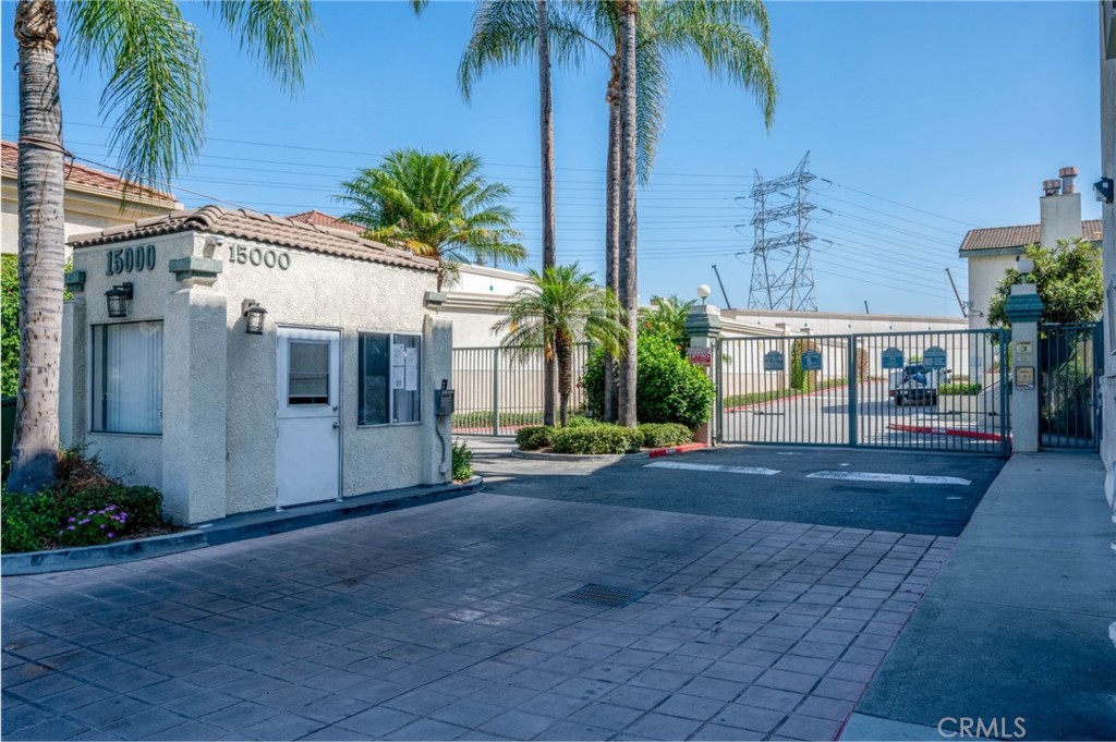 a view of a house with a yard and potted plants