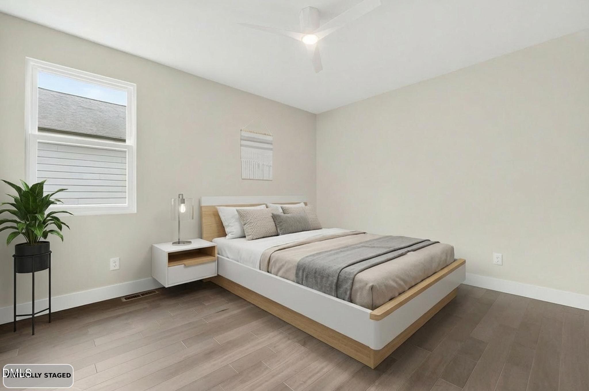 104 South Driver Street Durham, NC 27703 - Photo 38 of 53 a bedroom with a bed and a potted plant