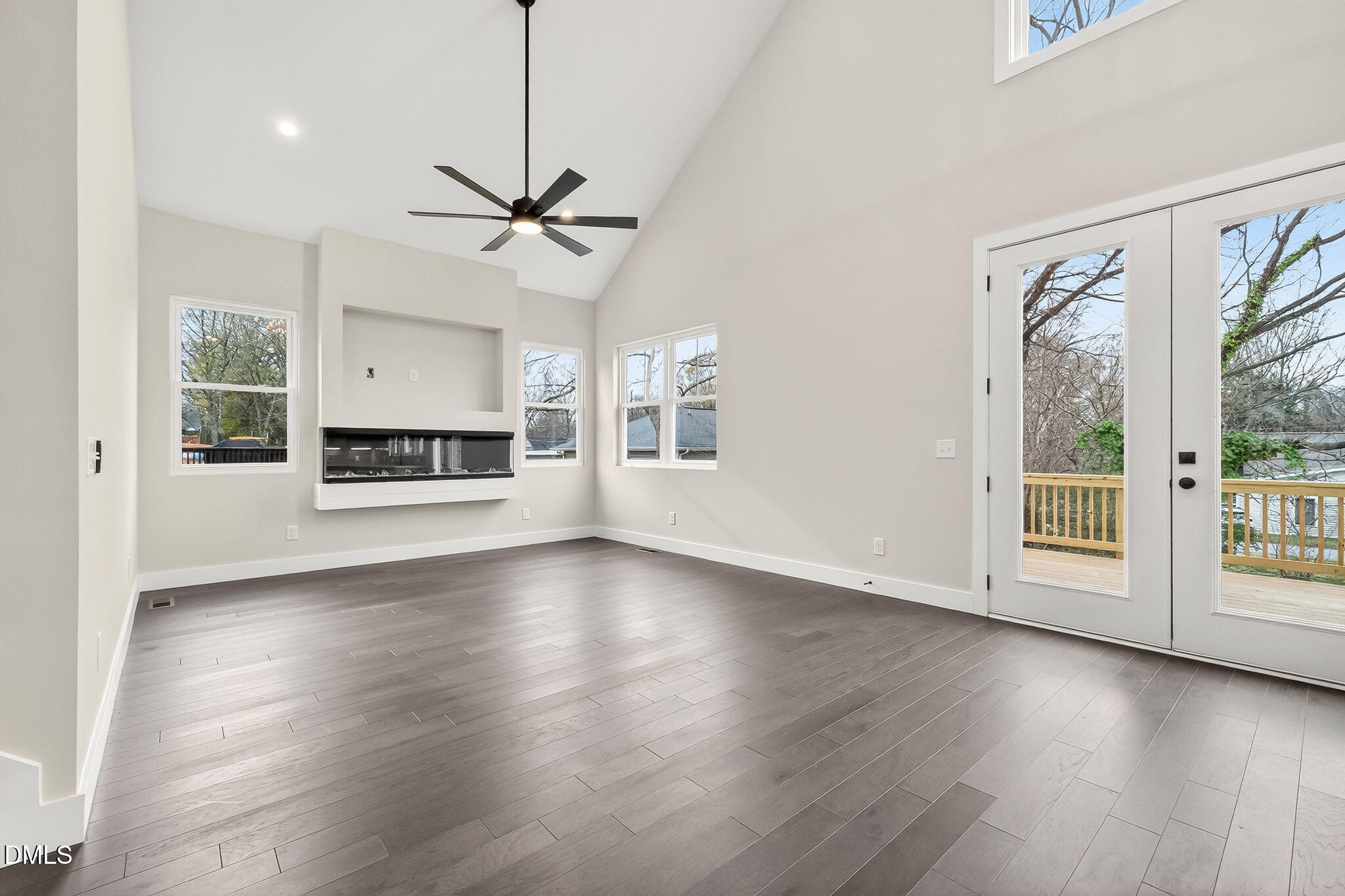 104 South Driver Street Durham, NC 27703 - Photo 10 of 53 a view of a livingroom with wooden floor a ceiling fan and windows