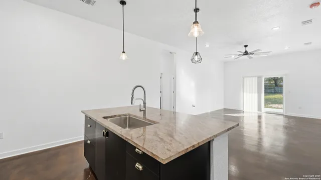 a kitchen with a stove a sink and a refrigerator