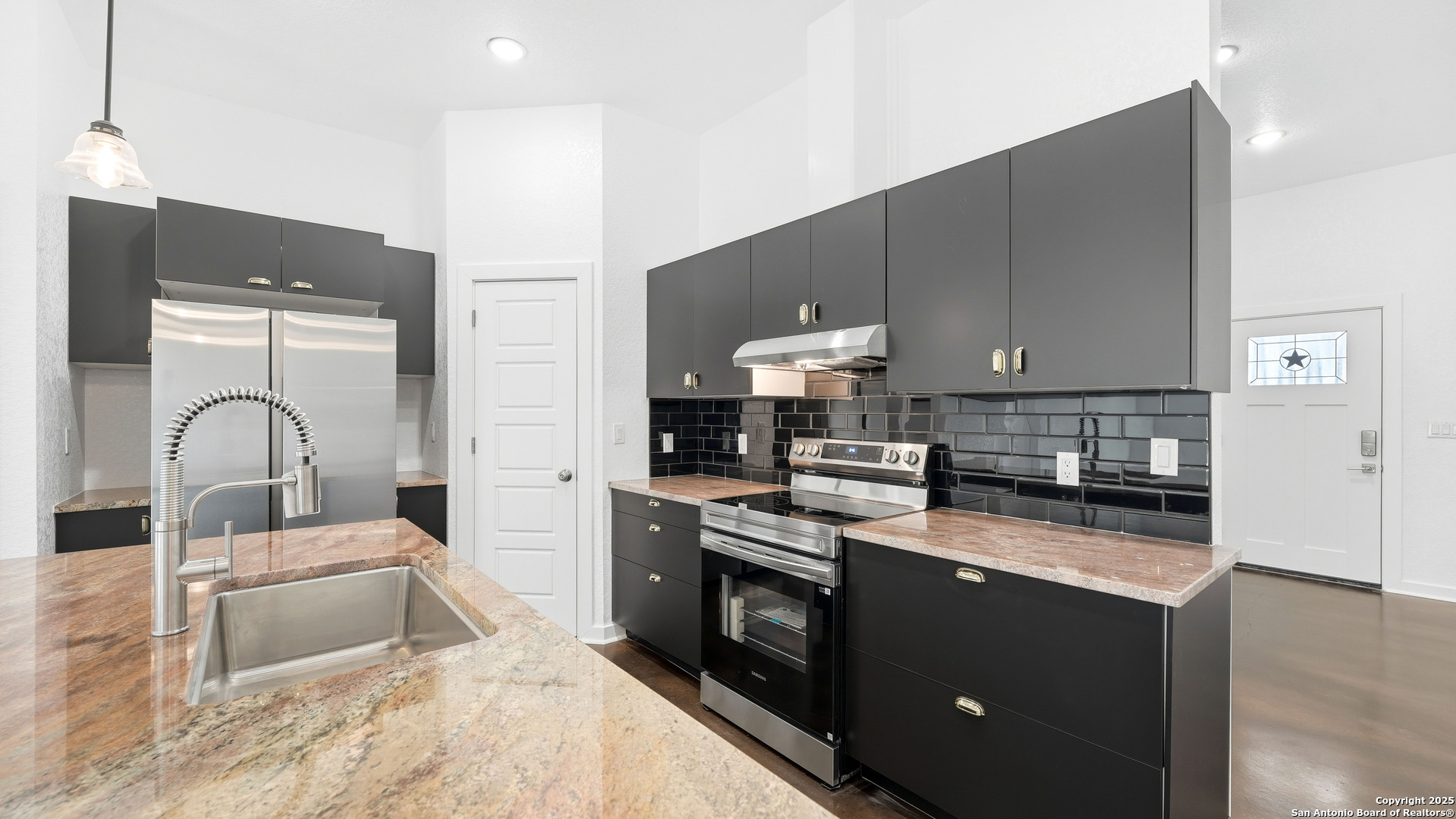 4606 Lee Way Elmendorf, TX 78112 - Photo 12 of 45 a kitchen with a stove a sink and a refrigerator