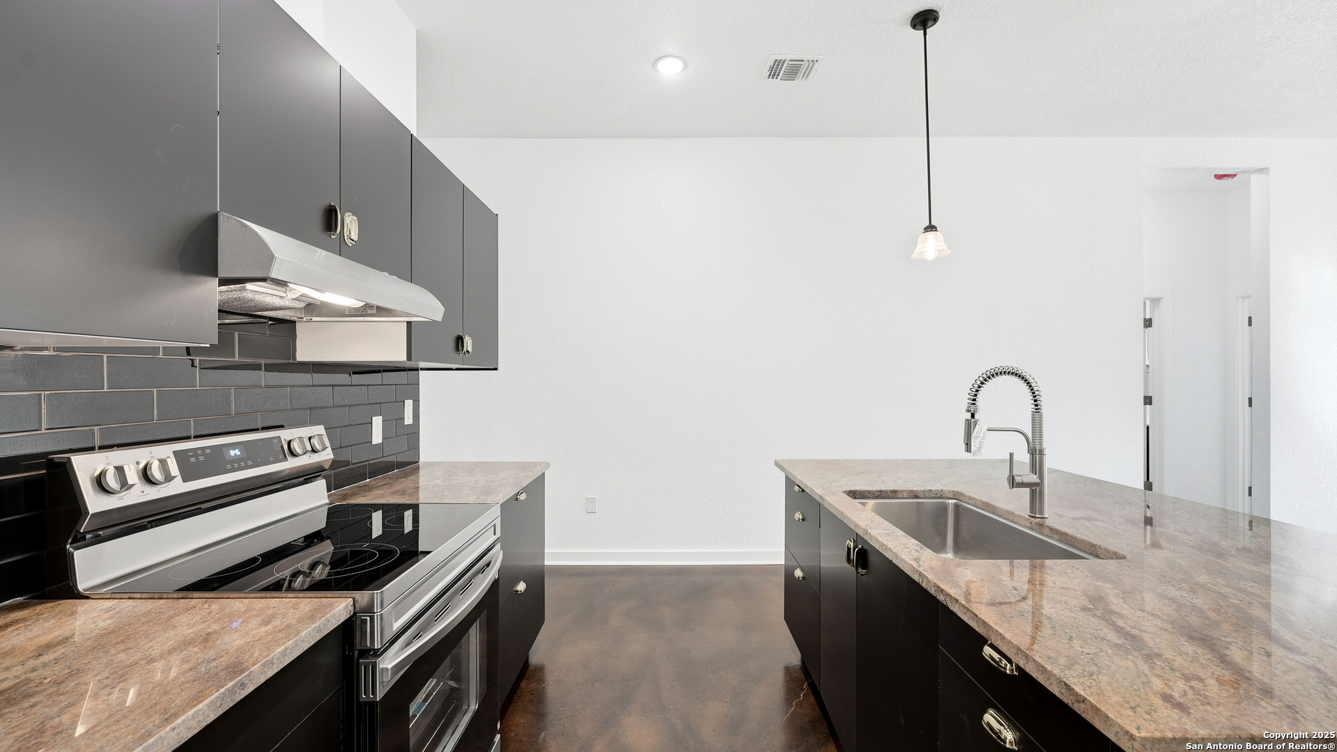 4606 Lee Way Elmendorf, TX 78112 - Photo 14 of 45 a kitchen with granite countertop a stove a sink and a table