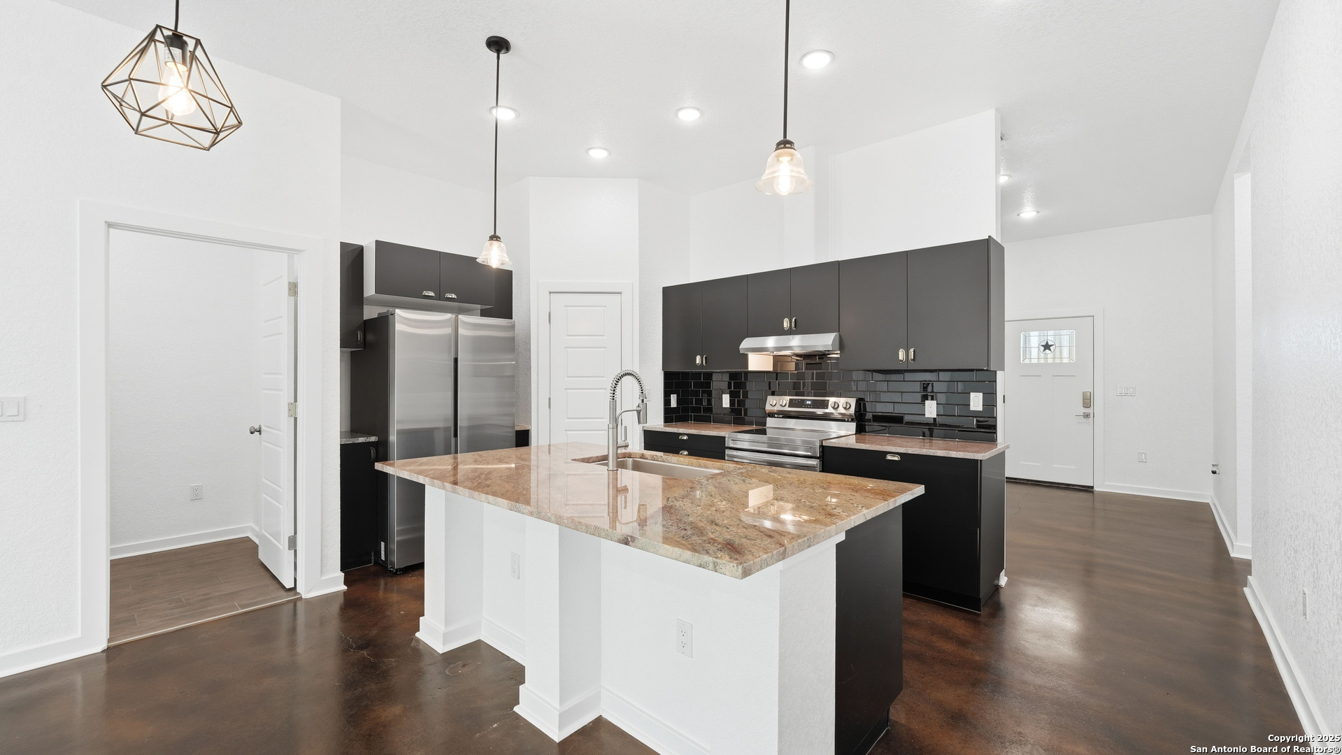 4606 Lee Way Elmendorf, TX 78112 - Photo 17 of 45 a large kitchen with stainless steel appliances granite countertop a refrigerator a oven and a sink