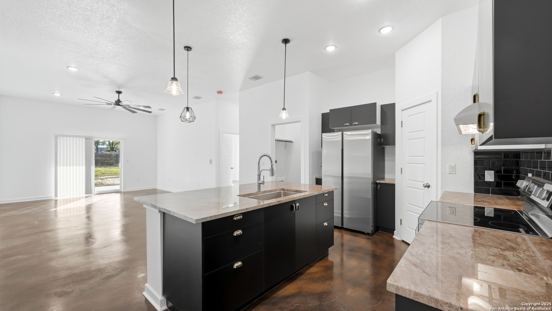 4606 Lee Way Elmendorf, TX 78112 - Photo 19 of 45 a kitchen with stainless steel appliances granite countertop a refrigerator a sink dishwasher and a oven with wooden floor